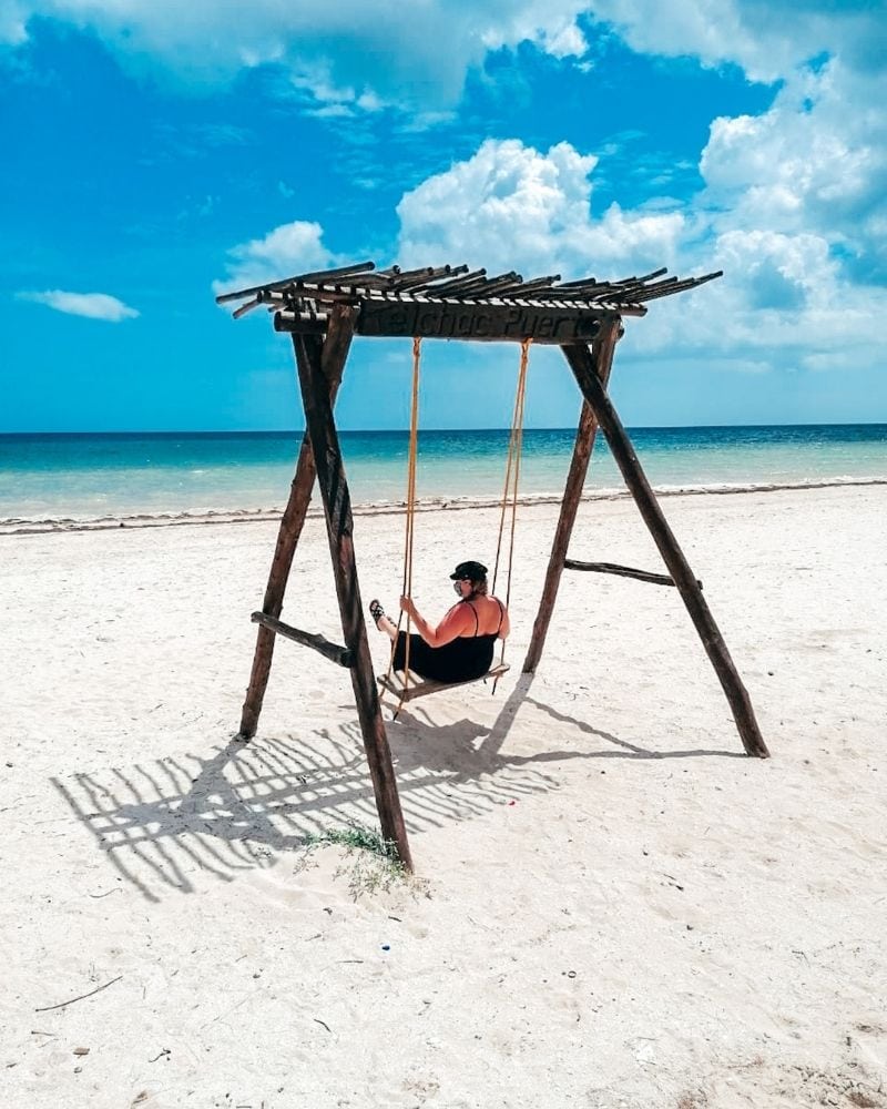 woman on a swing in Telchac Beach Yucatan | best Merida Mexico beaches