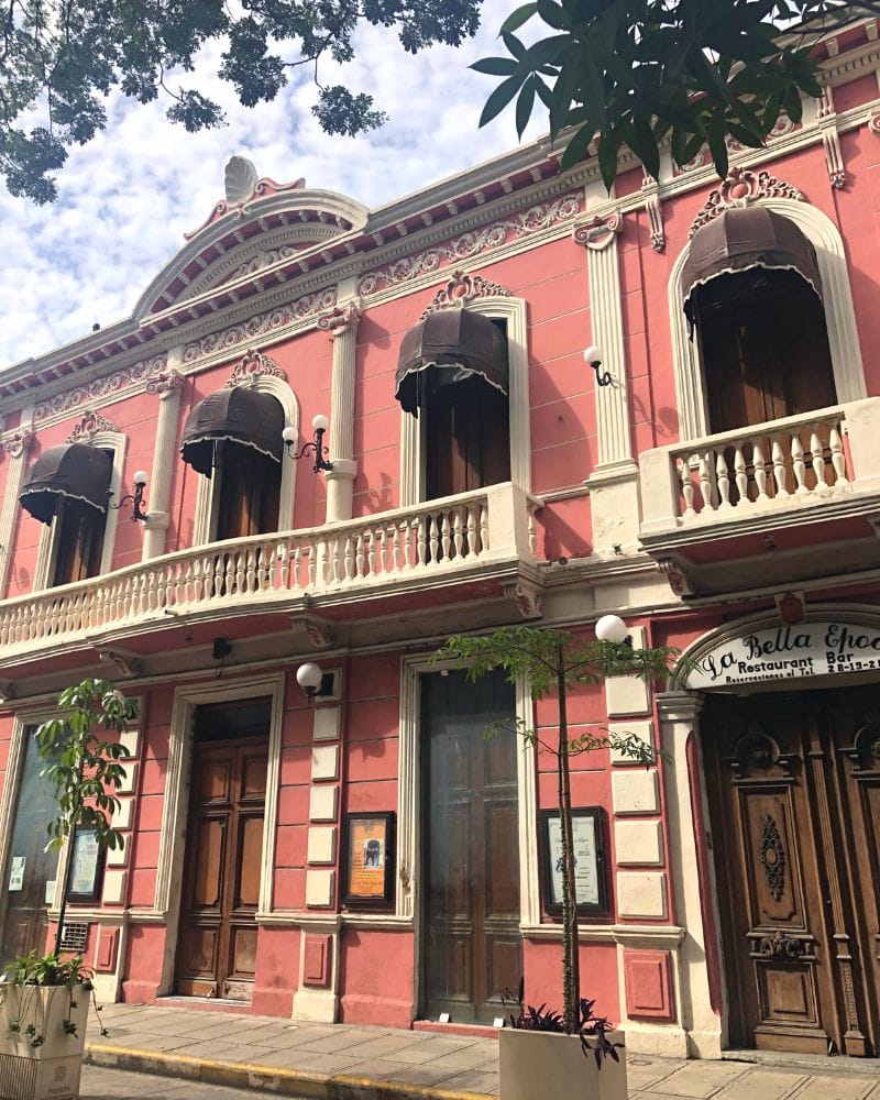 pink colonial building in downtown merida mexico
