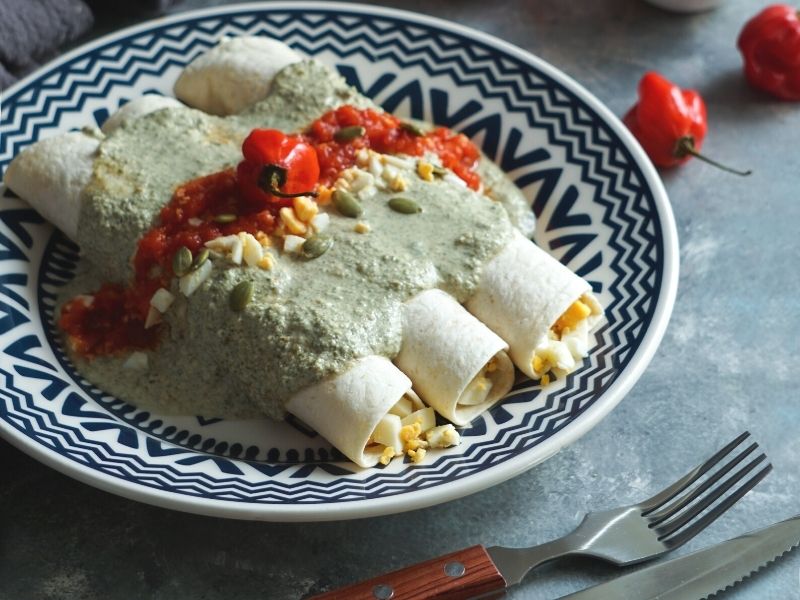 enchiladas with egg and pumpkin seed saucelechon pork | best yucatan foods
