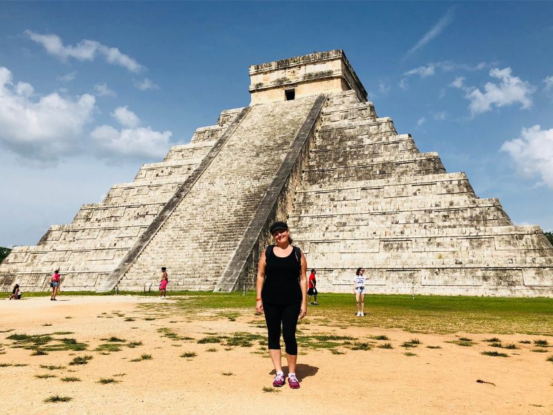 woman on a chichen itza private tours in front of the El Casillo pyramid