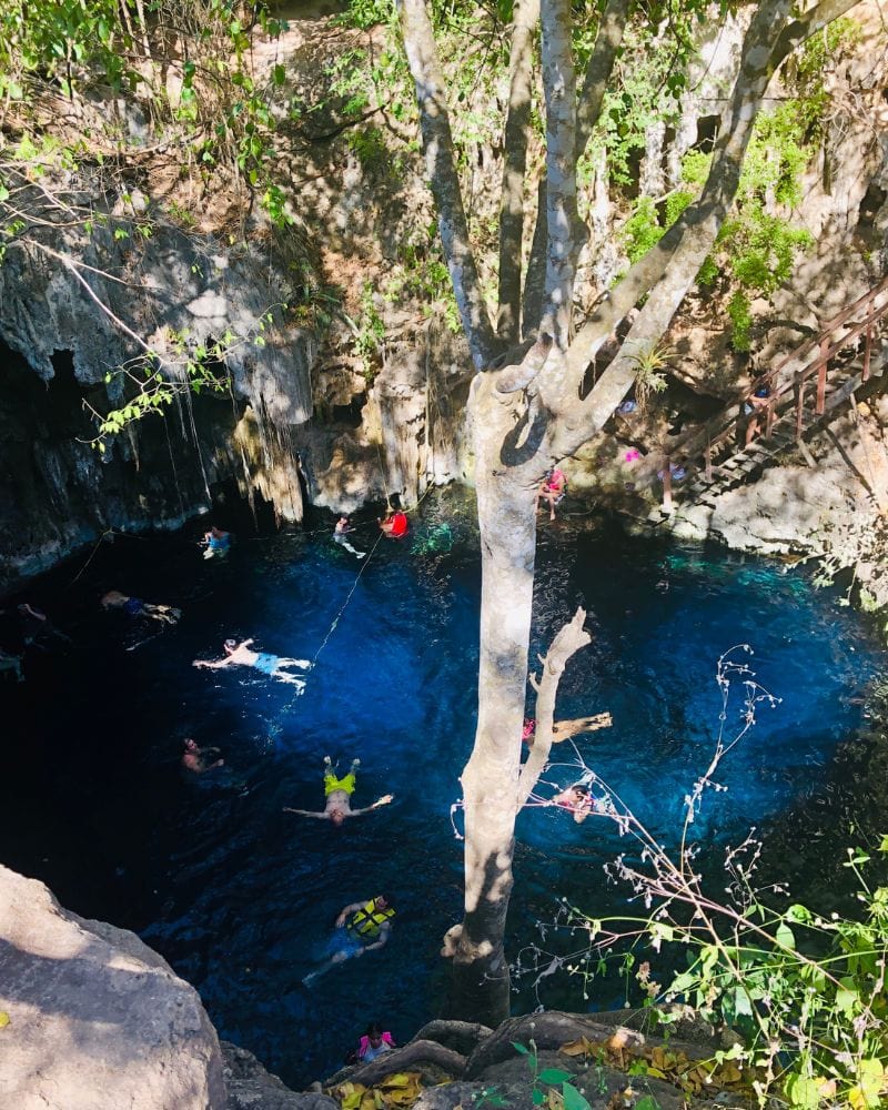 people swimming in cenote mucuyche (cenote yaal utzil)