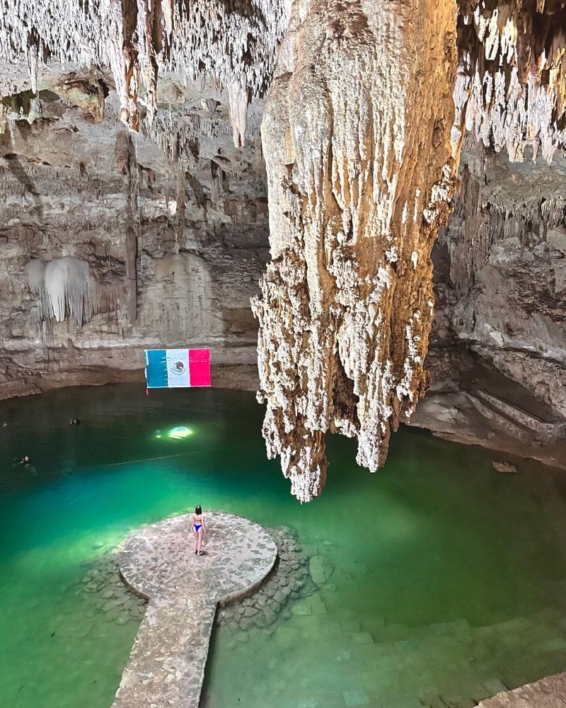 woman in the middle of circular platform in cenote suytun
